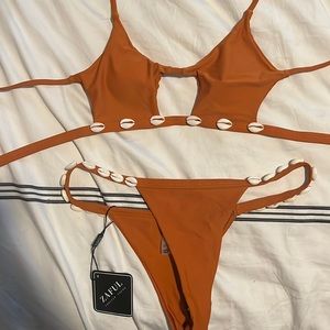 Never worn Zaful swim suit. Orange with shells. Size 6 but fits like. 0/2